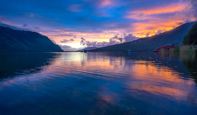 A colorful sunset over Puyuhuapi’s Bay with mountains and hills in the distance