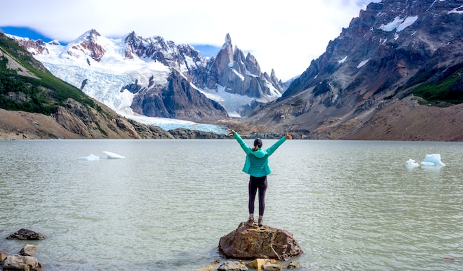 Kristin Addis stands on a stone in the waters of Cerro Torre in Patagonia