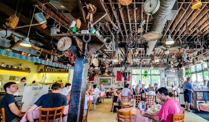 The interior of Big Ed's restaurant, with lots of diners sitting at tables and antiques hanging from the ceiling in Raleigh, North Carolina