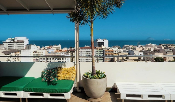 Rooftop terrace overlooking the city, beach, and ocean at Aquarela do Leme hostel Rio de Janeiro, Brazil