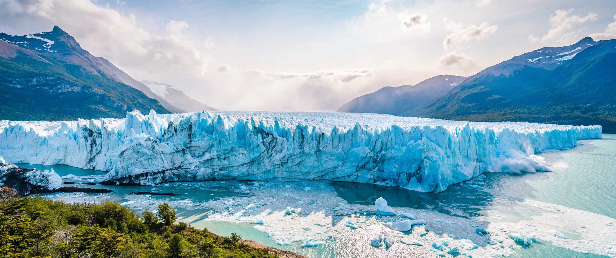 The stunning Perito Moreno Glacier under a bright blue sky in Los Glaciares National Park in Patagonia, Argentina