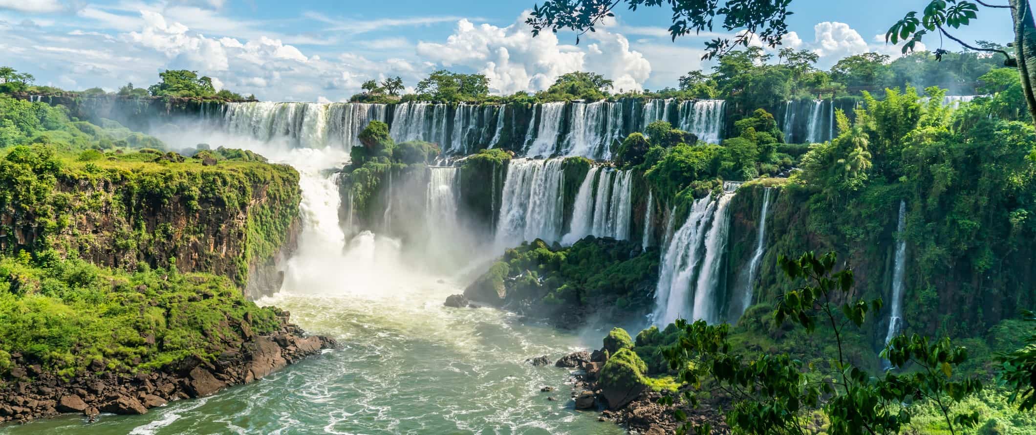 The waterfalls of Iguazu Falls, surrounded by lush greenery, in Argentina