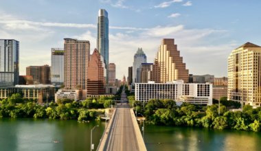 he towering skyline of Austin, Texas as seen from over a bridge