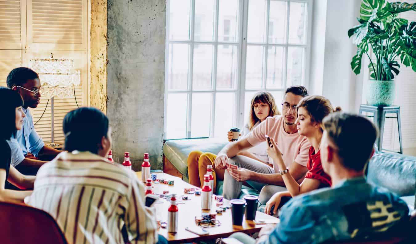 A bunch of backpackers hanging out at a hostel in the common area