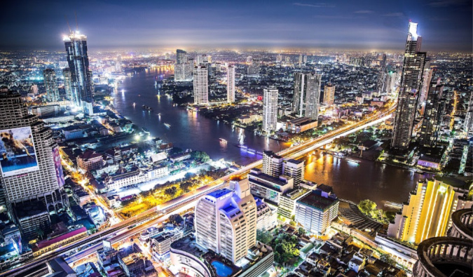 Bangkok at night with towering skyscrapers in the distance