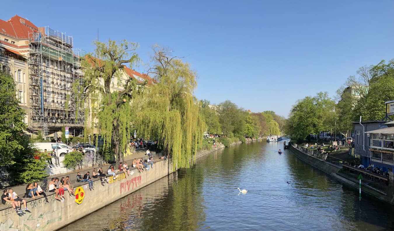 Locals relaxing near the river in the charming neighborhood of Kreuzberg in Berlin, Germany