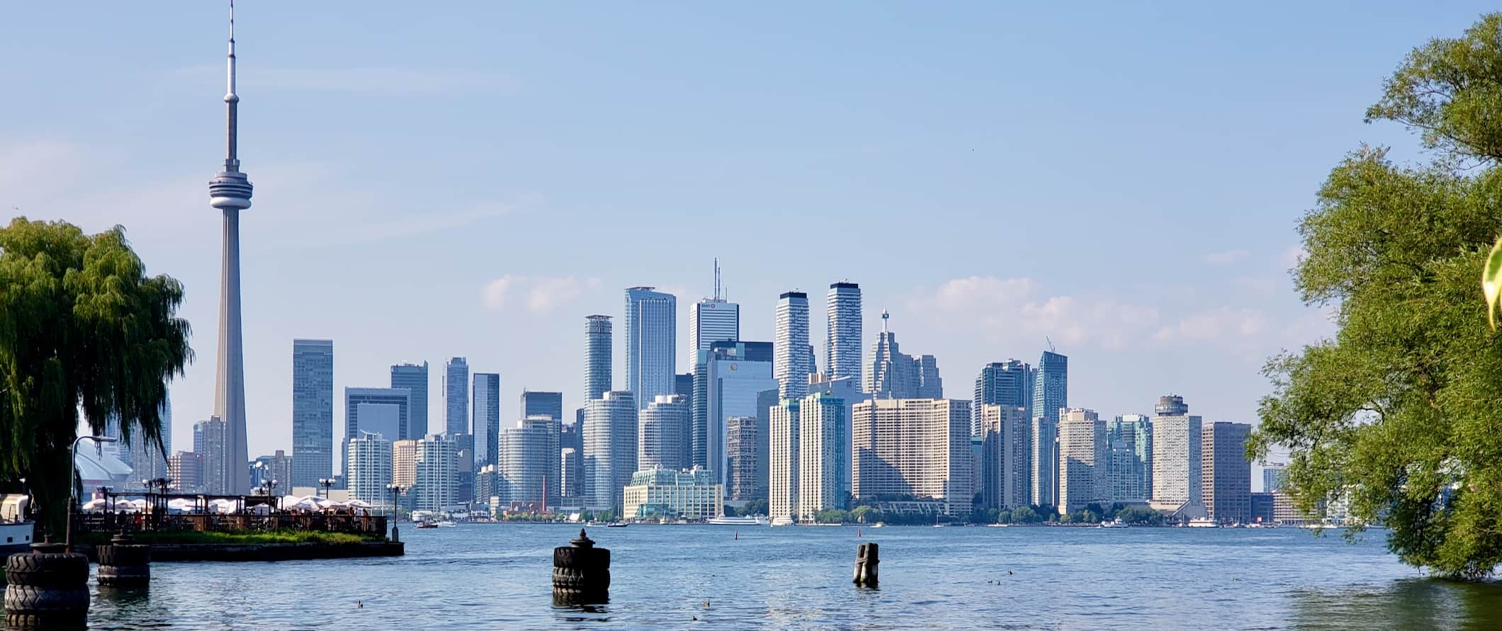 The CN Tower and skyline of Toronto as seen from the island out on Lake Ontario