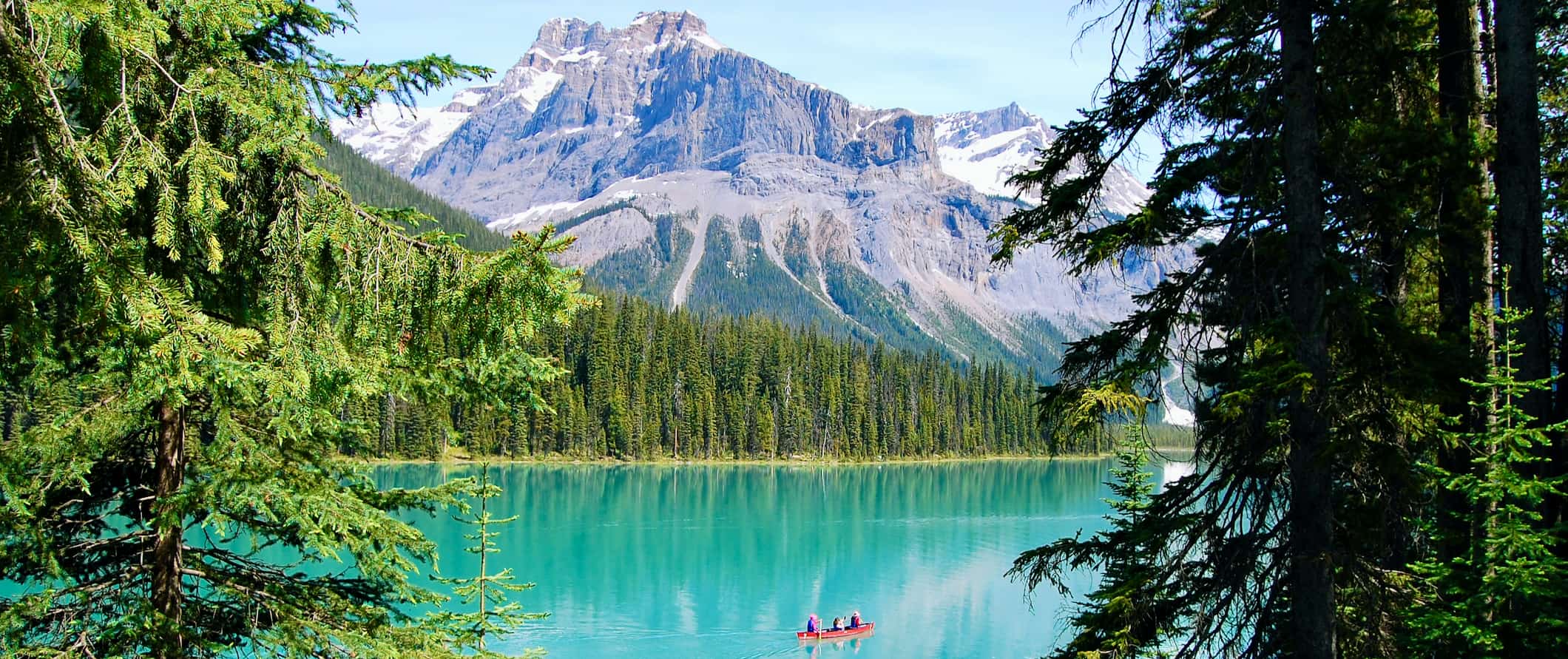 A person in a small kayak on the calm waters of Lake Louise near Banff, Alberta