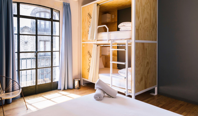 One of the beautiful dorm rooms with wooden bunk beds at the Casa Pepe hostel in Mexico City