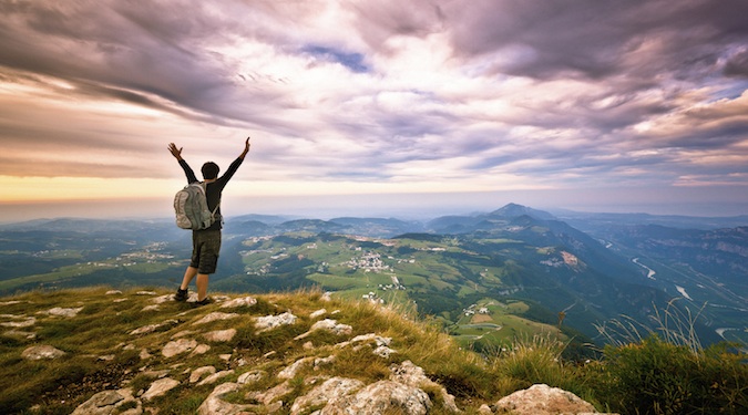 A man excited to have climbed a mountain