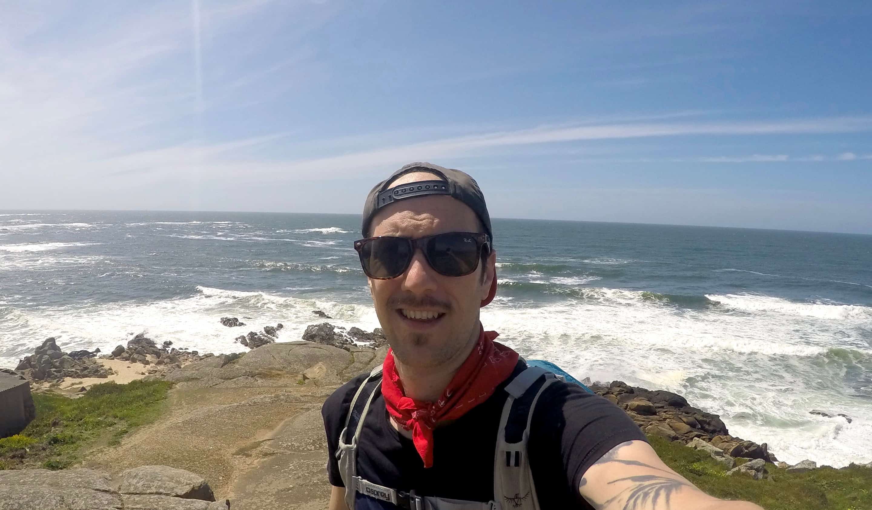 Chris Oldfield, a vegan traveler posing while on the Camino in Portugal