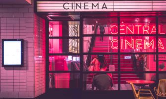 The neon lights of an old cinema at night