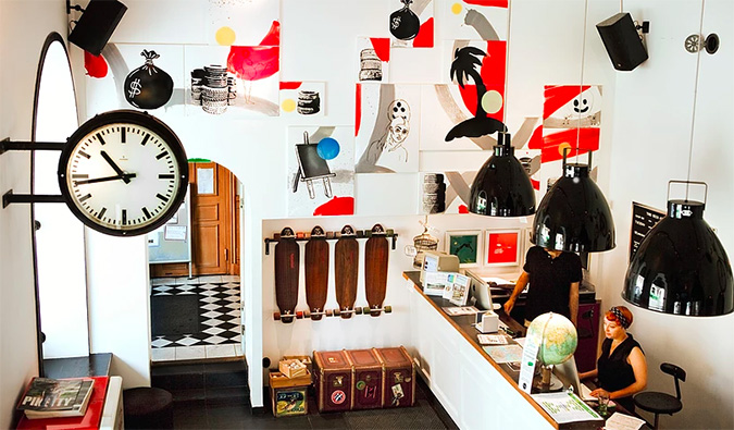 Overhead view of lobby with front desk and art on the walls at City Backpackers, Stockholm