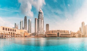 The towering skyline of downtown Dubai, as seen from the water with huge buildings in the background