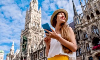 A solo female traveler using her eSIM and smartphone while traveling Europe