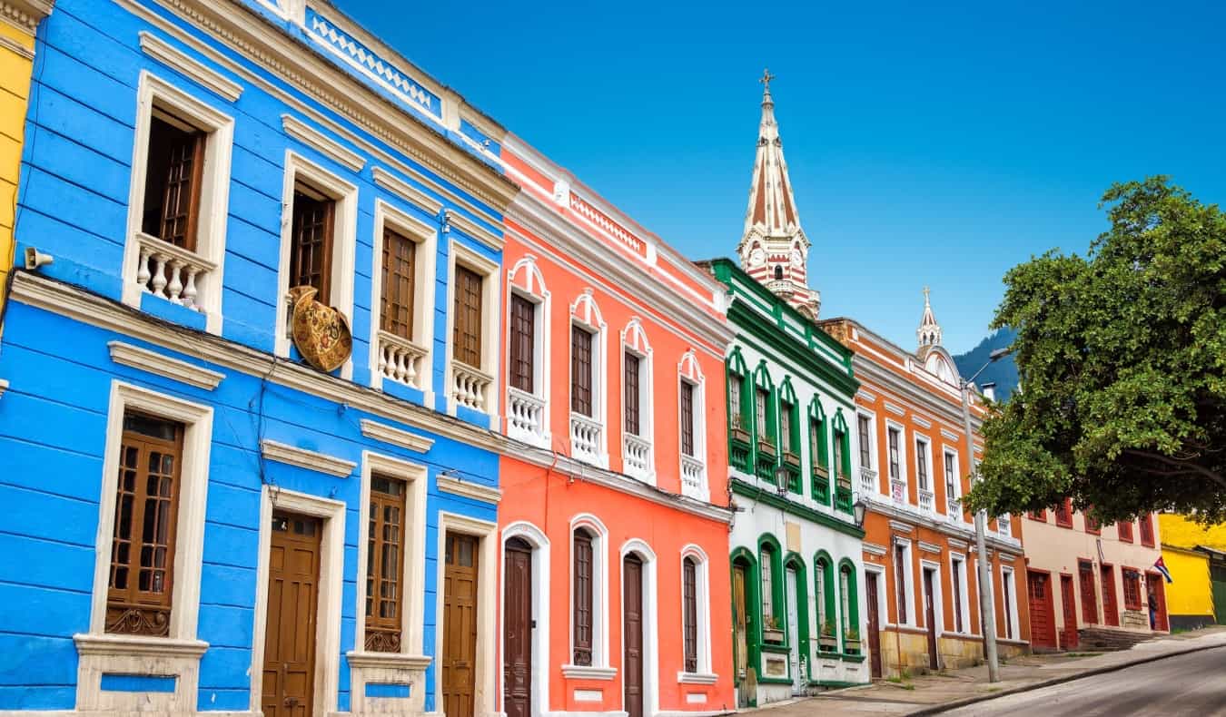 Brightly colored buildings lining a street in the historic neighborhood of La Candelaria in Bogotá, Colombia