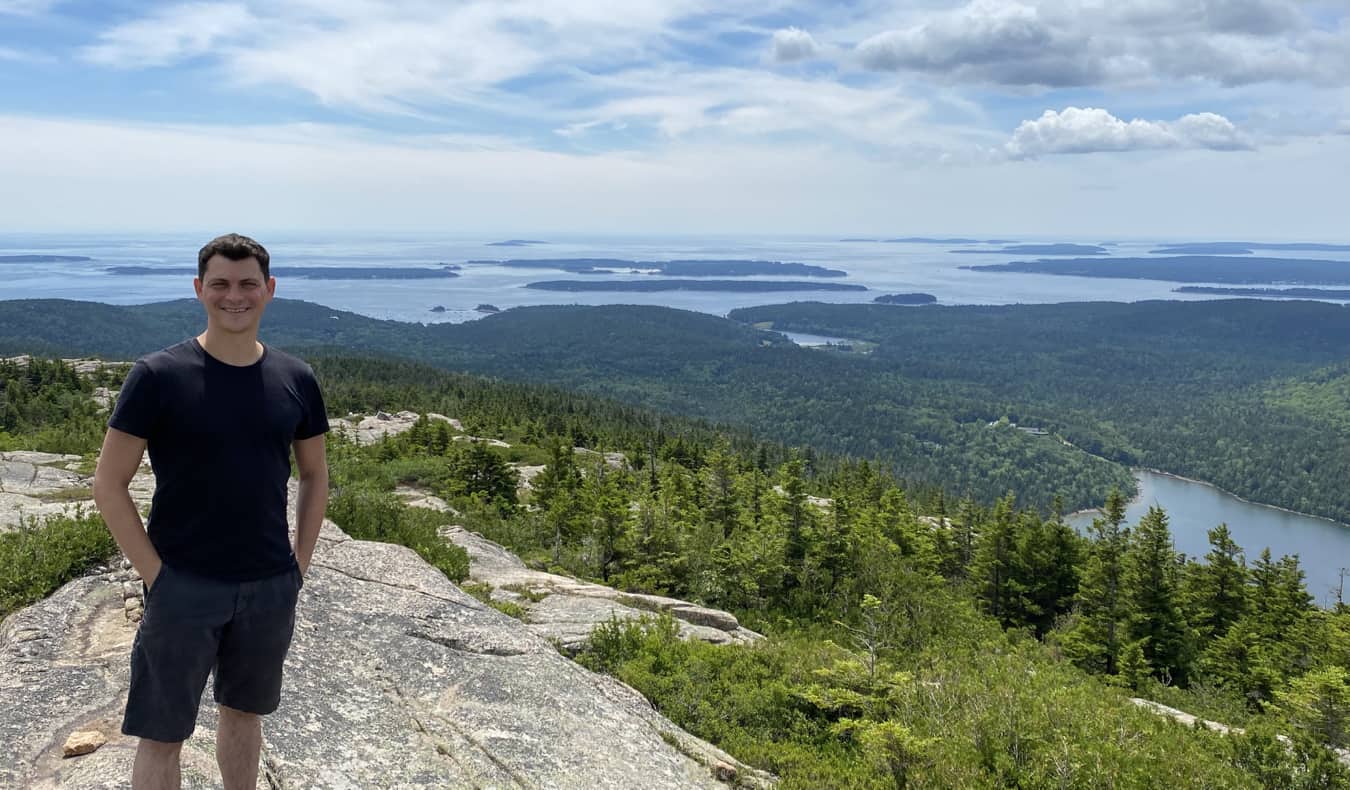 Nomadic Matt posing for a photo in Acadia National Park, Maine