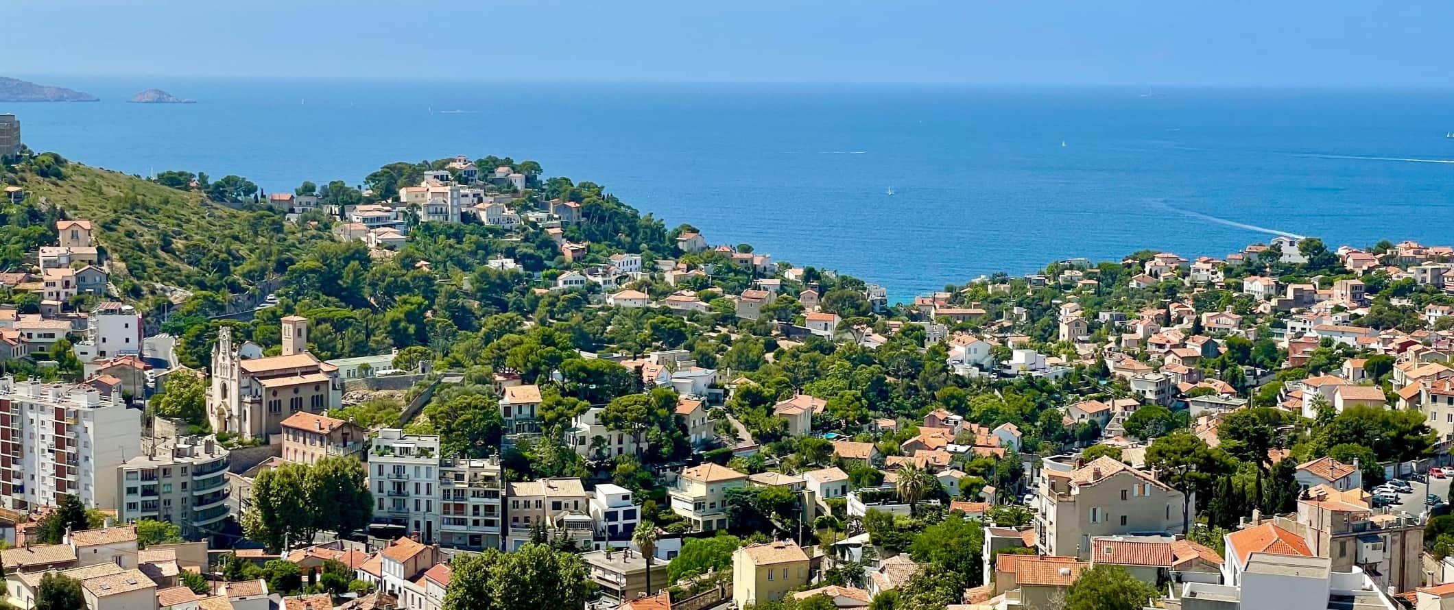 The rolling hills of the city Marseille, France, with the Mediterranean Ocean in the background