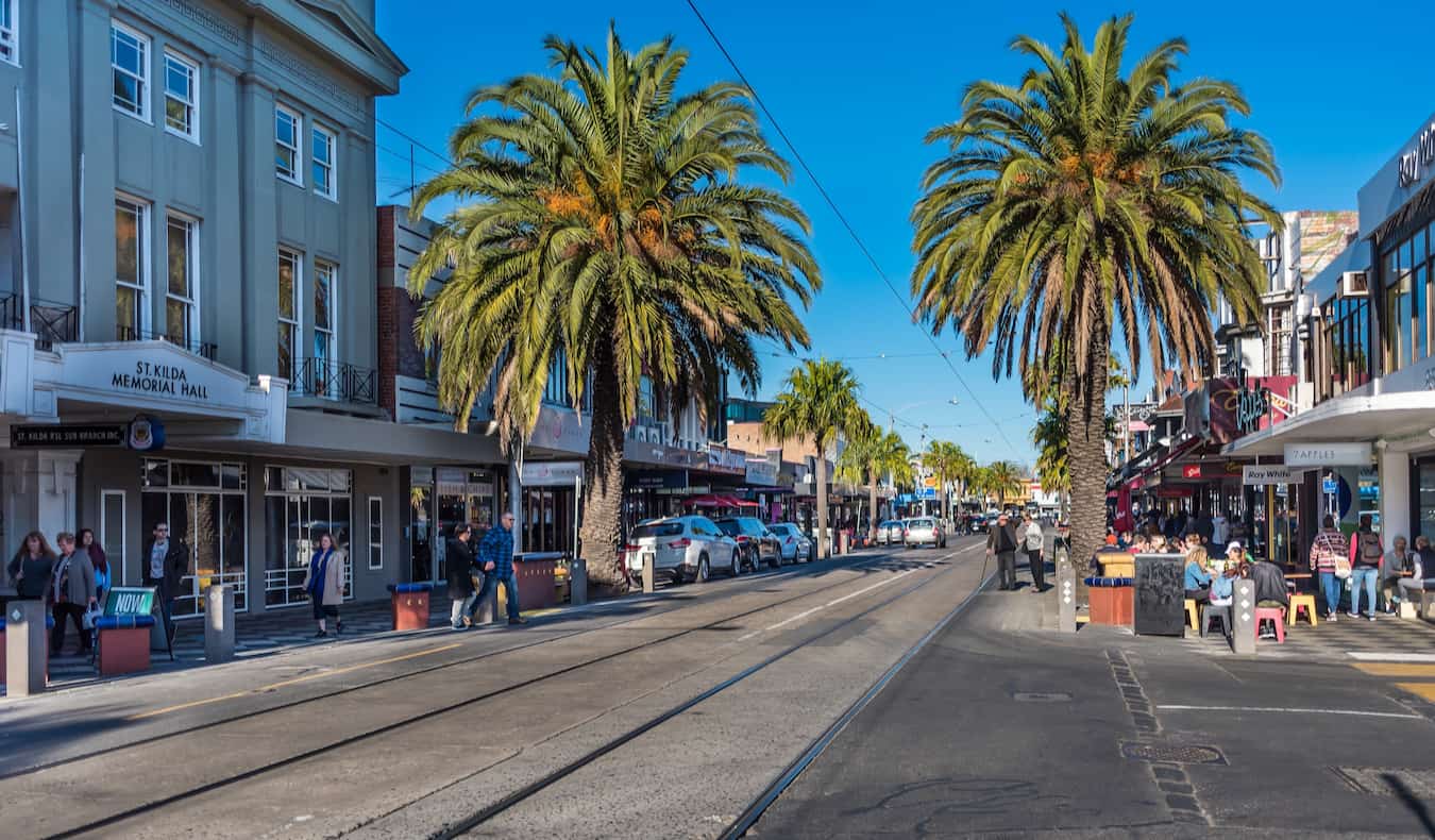 People relaxing on a street in St Kilda, Melbourne on a bright and sunny day