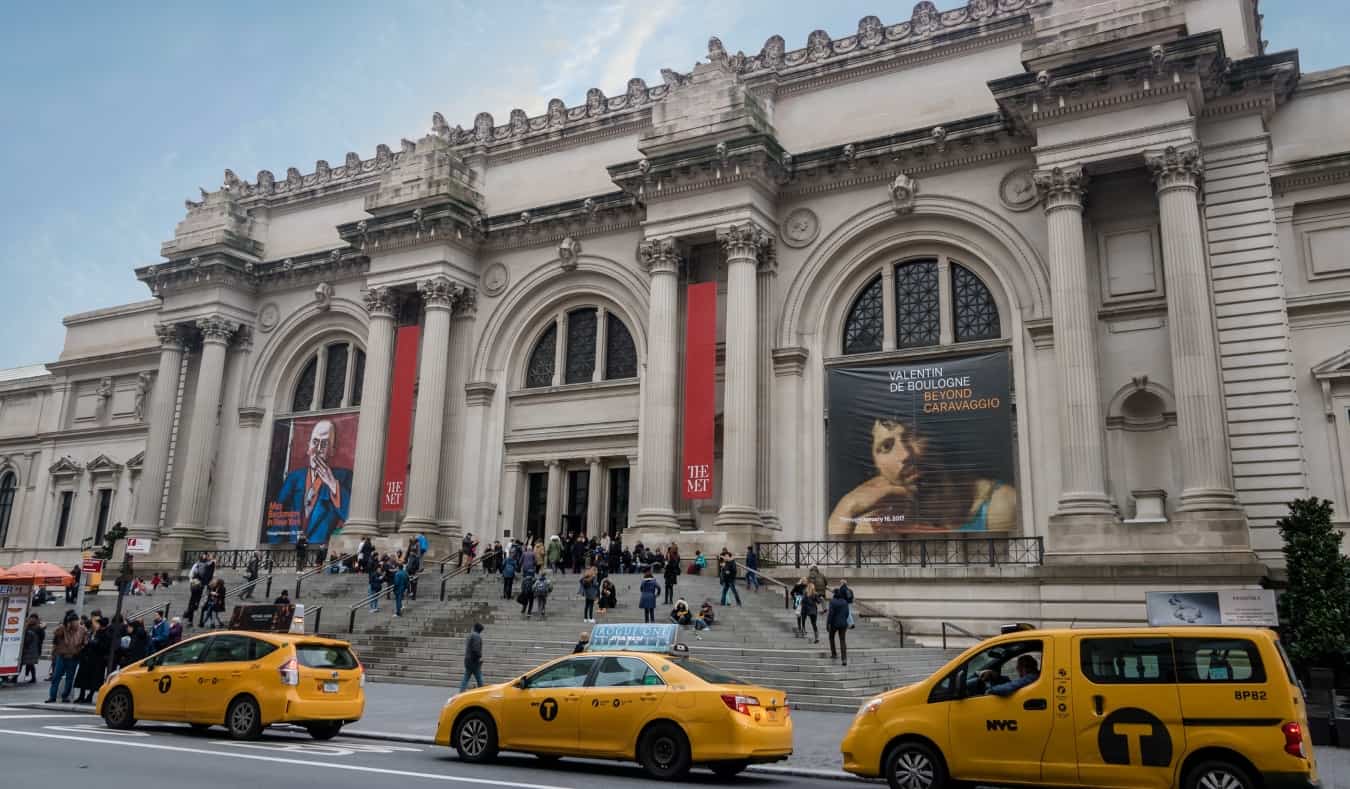 Yellow taxis in front of the sprawling staircase at The Metropolitan Museum of Art in NYC, USA