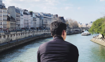 Matt of Nomadic Matt looking out onto a canal in Paris