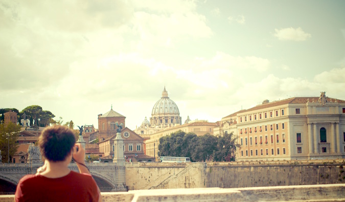 A solo traveler taking a picture in European city during the day