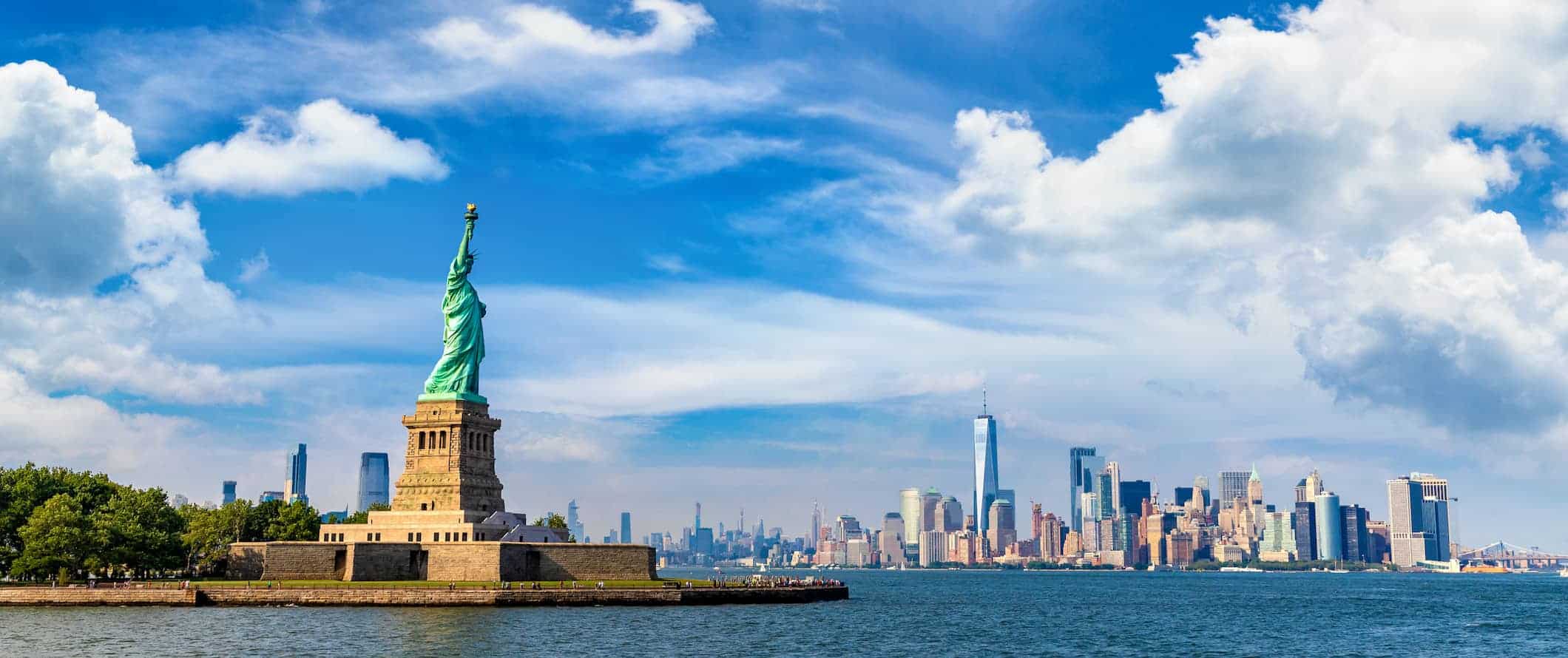 The Statue of Liberty and the NYC skyline as seen from the water in New York