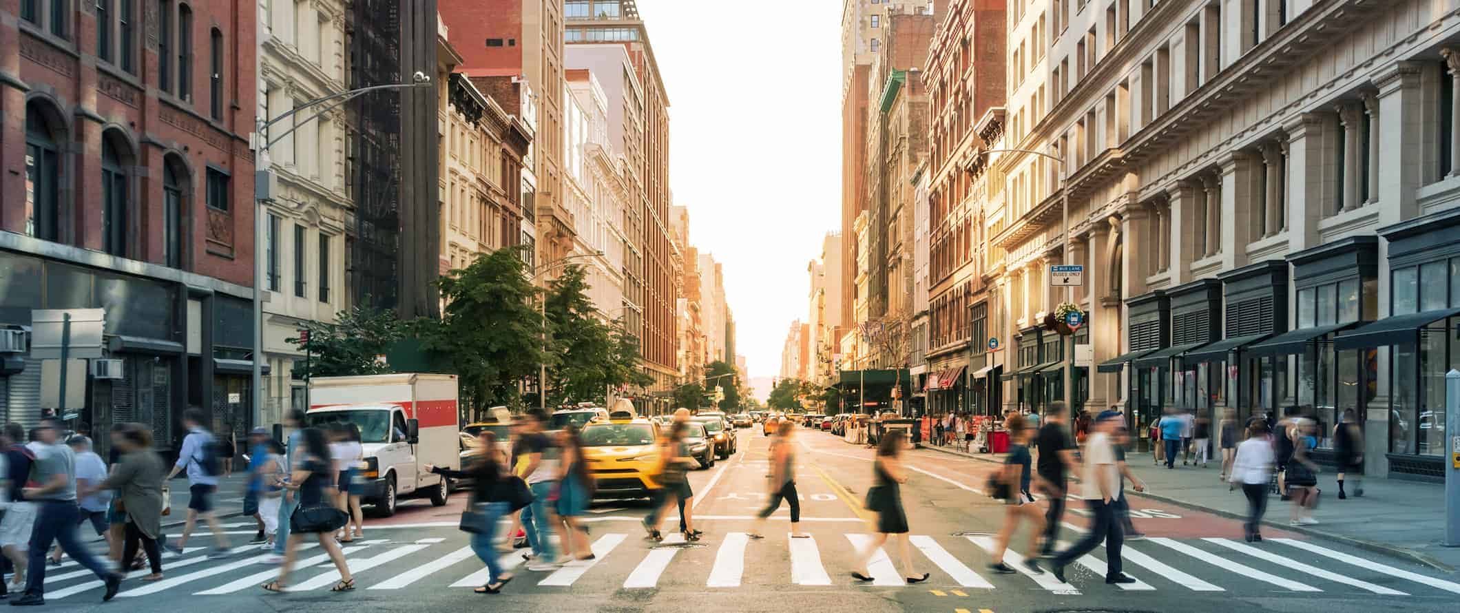 People crossing the street on a busy road in Manhattan, NYC, USA