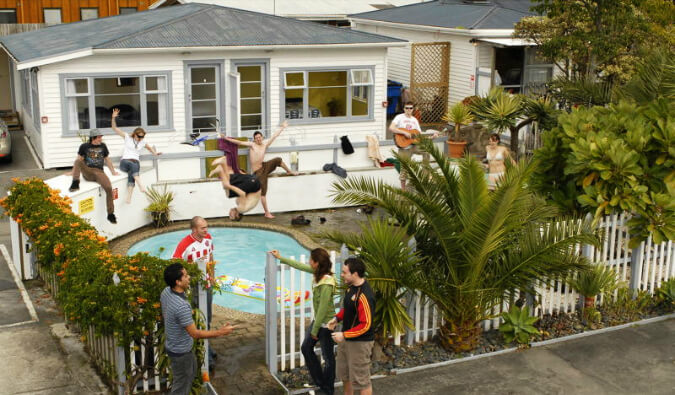 pool party with man drinking and jumping in to the pool