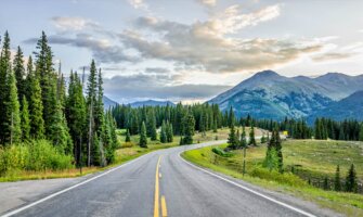 The wide open road on a road trip through a beautiful natural landscape abroad