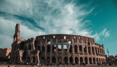 The ancient Roman Coliseum set against a blue sky in summer in Rome, Italy