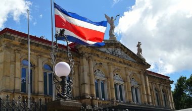 The Costa Rican flag waving in front of the historic theater in San José, Costa Rica