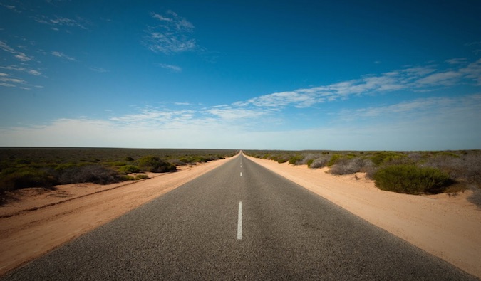 a road going into the horizon on a sunny day