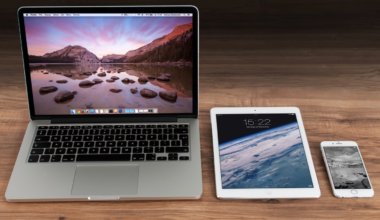 A laptop, tablet, and smartphone sitting on a desk