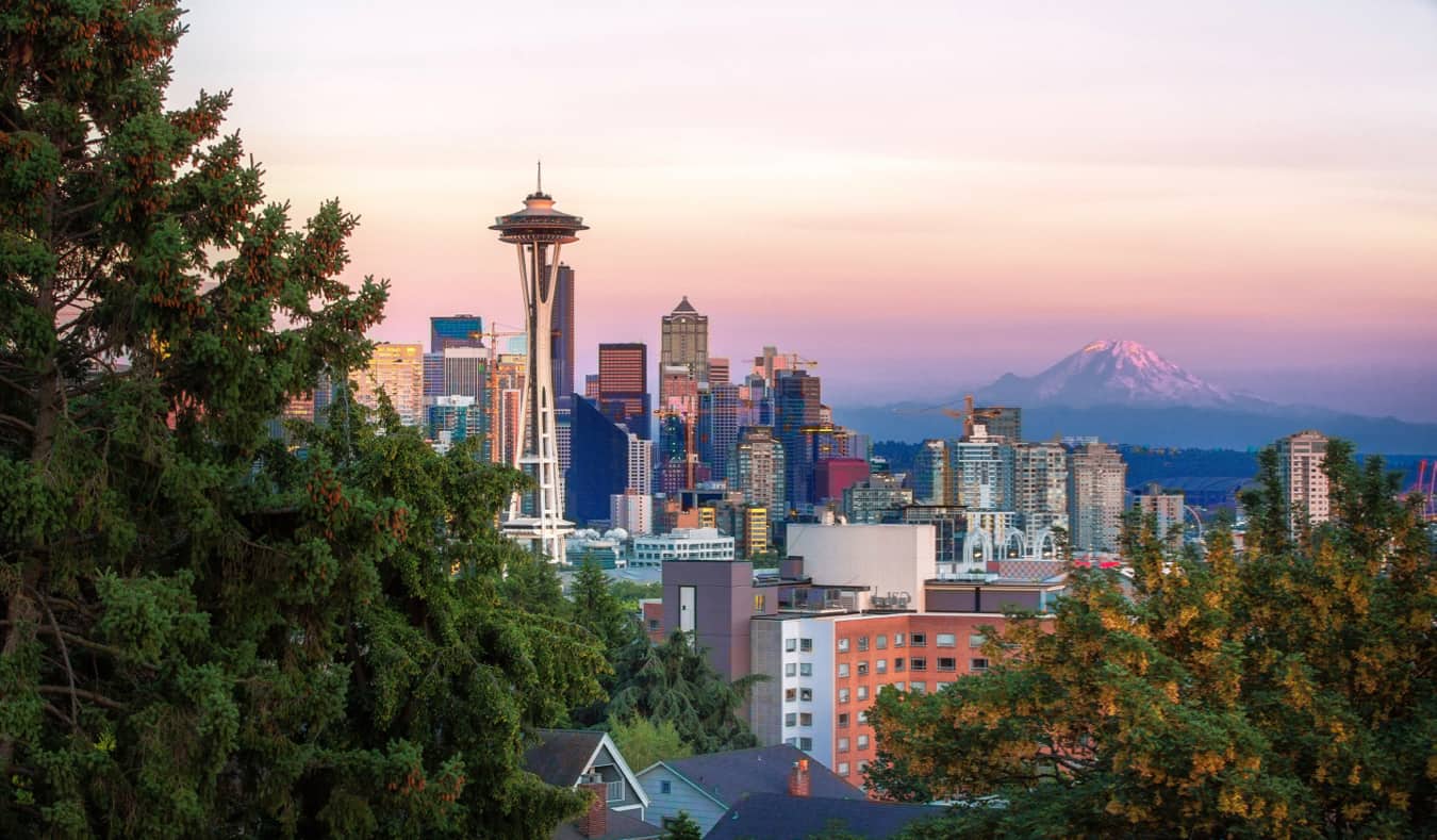 The view of Seattle and the Space Needle with a looming mountain in the distance