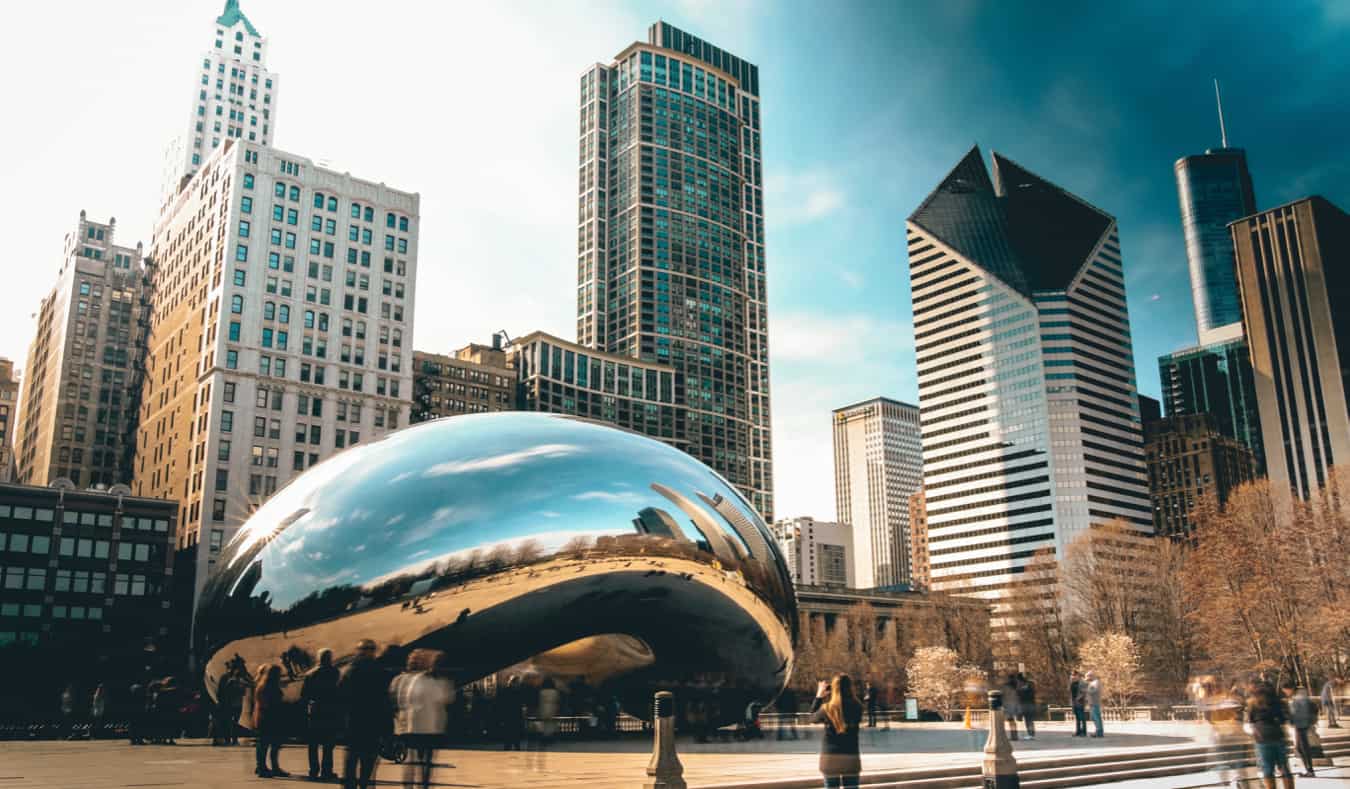 A long-exposure shot of the famous silver bean in Chicago surrounded by people